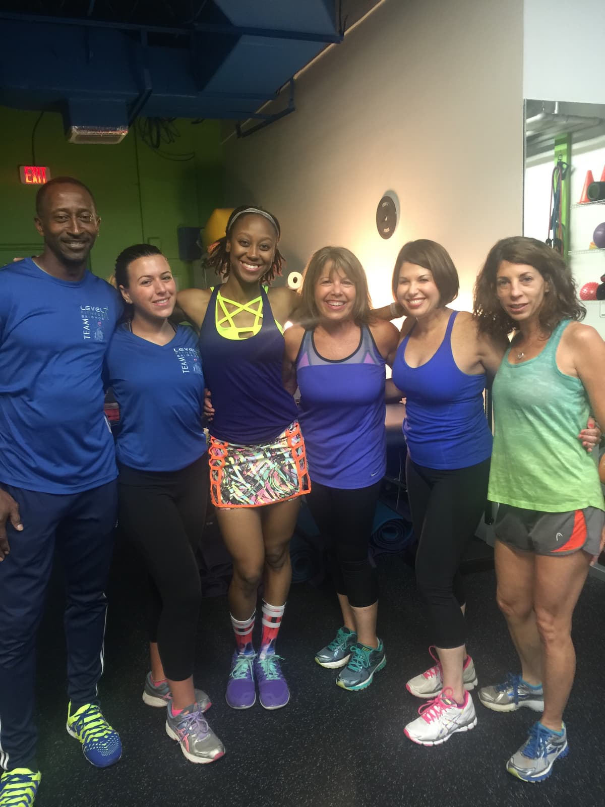 Level 7 instructor surrounded by her dedicated class members