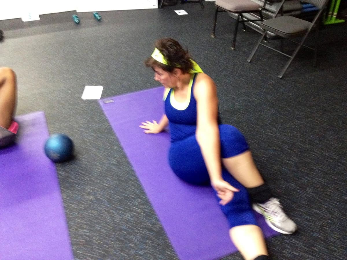 Karen doing cool down stretch during a group private training